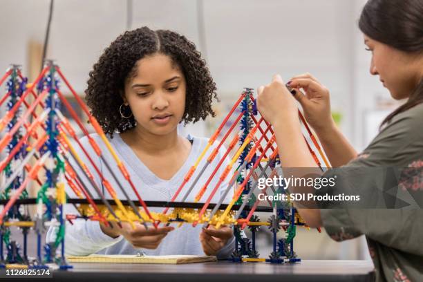 teen girls build bridge at school using model kit - public school building stock pictures, royalty-free photos & images