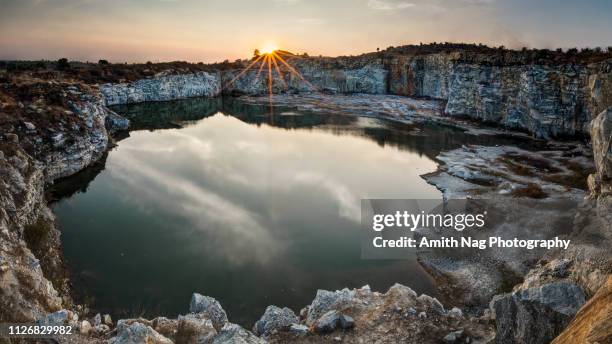 apocalyptic sunset at an old abandoned quarry - reflection water india stock pictures, royalty-free photos & images