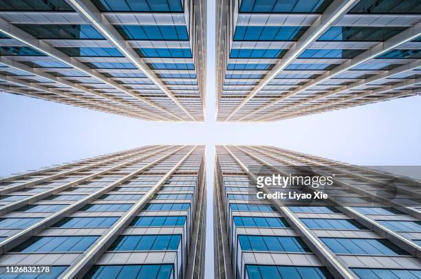 office building, low angel view - symmetry stock pictures, royalty-free photos & images