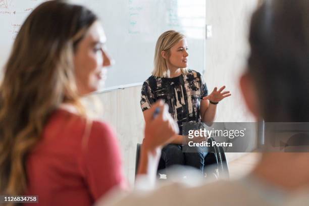 disabled manager explaining strategy in office - physical disability stock pictures, royalty-free photos & images