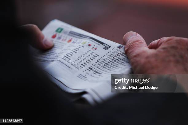 Punter reads the form guide during Melbourne Racing at Caulfield Racecourse on February 02, 2019 in Melbourne, Australia.