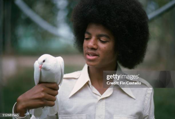 Michael Jackson , U.S. Singer-songwriter, poses with a bird sitting on his right hand, in Jamaica, 28 February 1975.