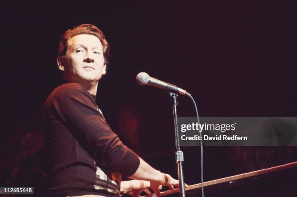 Jerry Lee Lewis, U.S. Rock and roll singer and pianist, playing the piano during a concert performance on stage at the Rainbow Theatre in Finsbury...