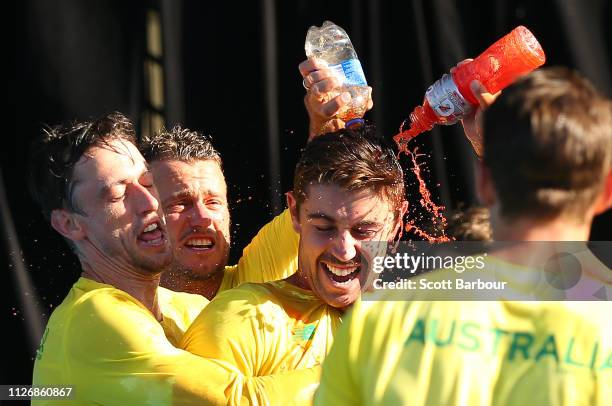 John Millman, captain Lleyton Hewitt of Australia and Jordan Thompson spray Gatorade as they celebrate after winning the Davis Cup Qualifiers between...