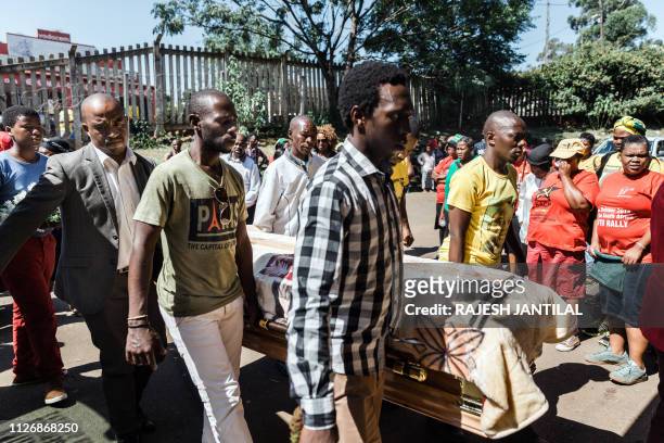 Members of the South African Communist Party and family members arrive with the coffin of their fallen comrade Mhlengi Khumalo during a funeral...