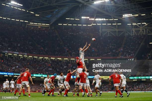 England's lock George Kruis jumps to win line-out ball during the Six Nations international rugby union match between Wales and England at the...