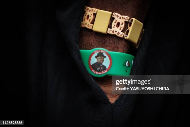 Man wears a bracelet of Rivers state's Governor Ezenwo Nyesom Wike at a polling station for Presidential and General election in Port Harcourt,...