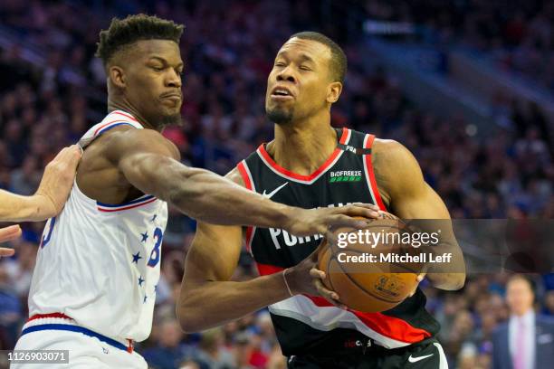 Jimmy Butler of the Philadelphia 76ers guards Rodney Hood of the Portland Trail Blazers in the first quarter at the Wells Fargo Center on February...