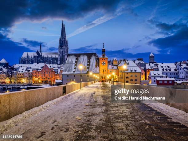 stone bridge on danube river with cathedral at night, regensburg, bavaria, germany - regensburg stock pictures, royalty-free photos & images