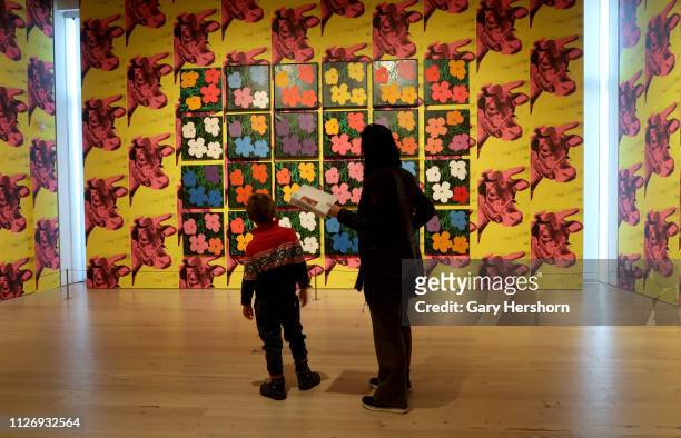 People attend the Andy Warhol " From A to B and Back Again" exhibit at the Whitney Museum of American Art on January 31, 2019 in New York City.