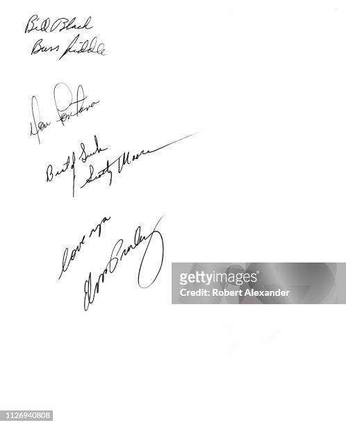 The back of an Elvis Presley publicity photograph contains autographs signed in 1956 by Presley and his three touring band members, Bill Black,...