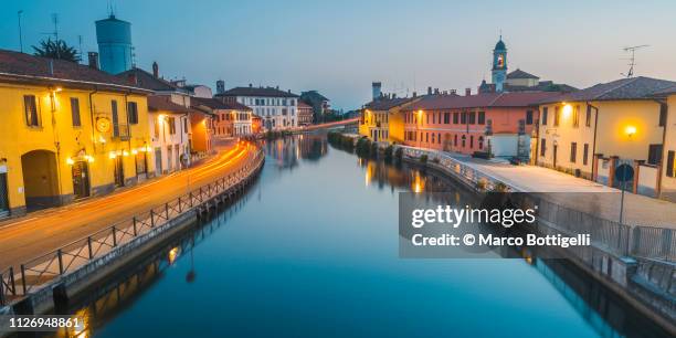 gaggiano at dusk, milan, italy - milano navigli stock-fotos und bilder