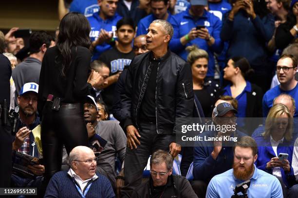 Former U.S. President Barack Obama talks with ESPN analyst Maria Taylor while attending the game between the North Carolina Tar Heels and the Duke...