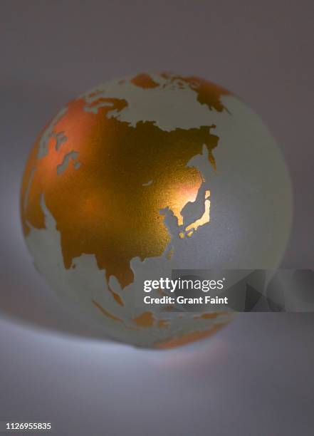 view of golden globe of earth - asia continent stockfoto's en -beelden