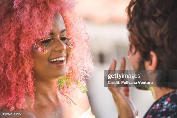 applying glitter on the skin - festival make up stock pictures, royalty-free photos & images