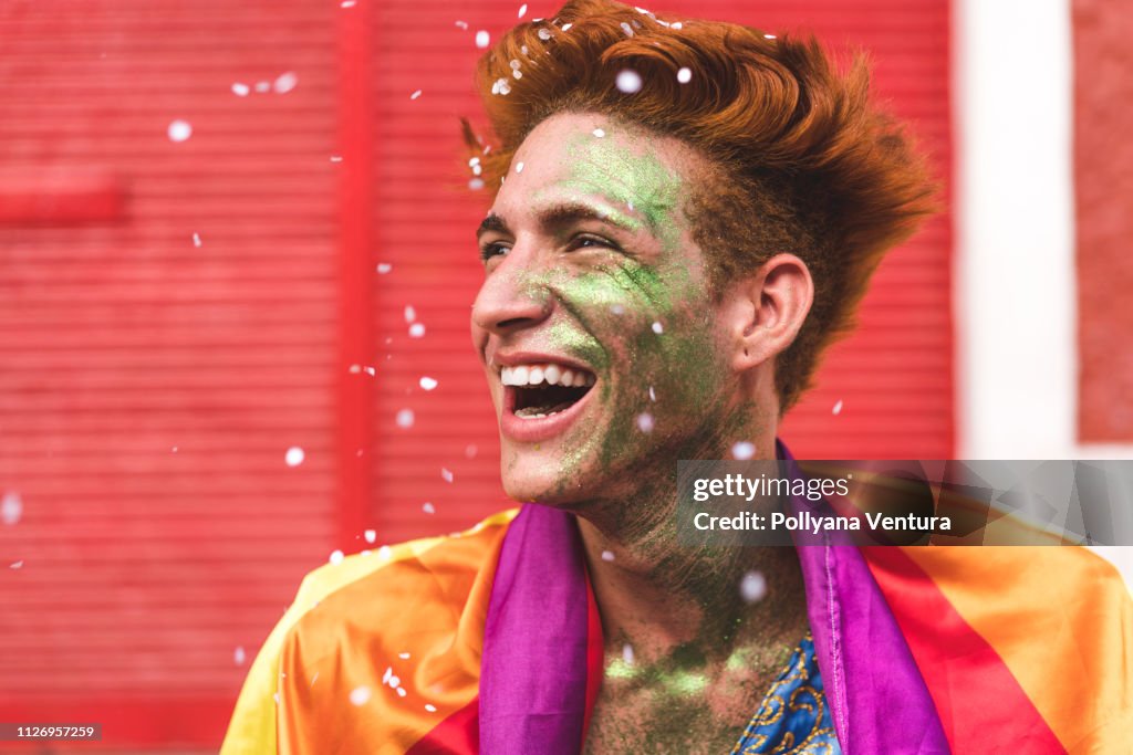 Man smiling in the rain of confetti