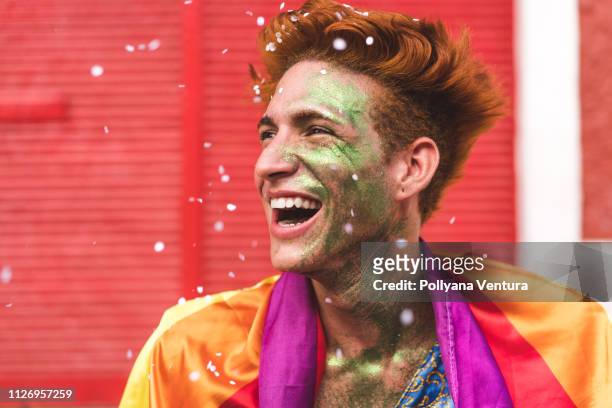 man smiling in the rain of confetti - fiesta stock pictures, royalty-free photos & images