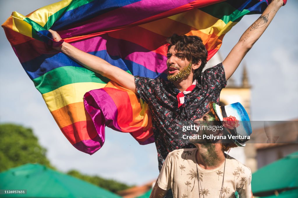 Gay couple holding the LGBT flag