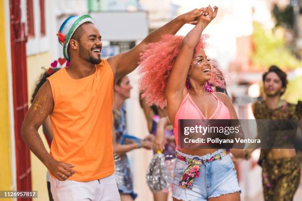 young people dancing at street carnival - samba dancer imagens e fotografias de stock