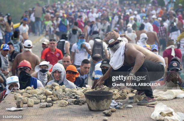 Demonstrator gets ready to throw a stone in clashes with the security forces at the Francisco de Paula Santander international bridge Bridge linking...