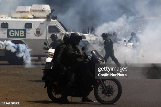 Riot policemen shoot tear gas during a protest against Venezuelan President Nicolas Maduro on February 23 to demand the entry of humanitarian aid in...