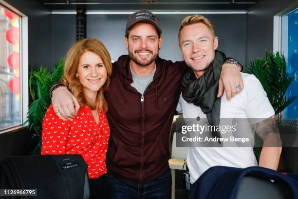 Breakfast show presenters Harriet Scott and Ronan Keating pose with his Boyzone bandmate Keith Duffy during a special live broadcast of Magic Radio...