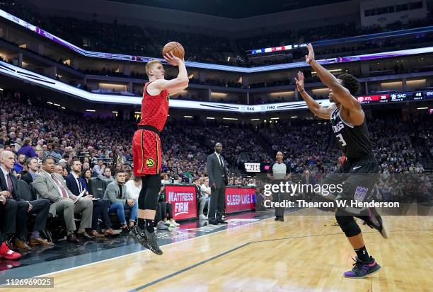 Kevin Huerter of the Atlanta Hawks shoots over Yogi Ferrell of the Sacramento Kings during an NBA basketball game at Golden 1 Center on January 30,...