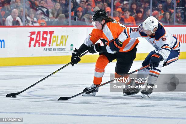 Nolan Patrick of the Philadelphia Flyers skates past Adam Larsson of the Edmonton Oilers at Wells Fargo Center on February 02, 2019 in Philadelphia,...