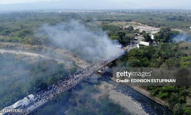 Aerial picture showing smoke billowing from trucks which were carrying humanitarian aid and which were set ablaze on the Francisco de Paula Santander...