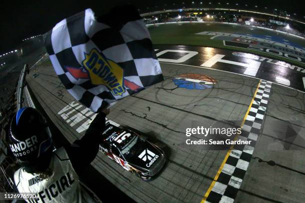 Kyle Busch, driver of the Cessna Toyota, crosses the finish line to win the NASCAR Gander Outdoors Truck Series Ultimate Tailgating 200 at Atlanta...