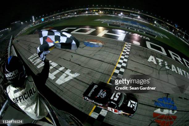Kyle Busch, driver of the Cessna Toyota, crosses the finish line to win the NASCAR Gander Outdoors Truck Series Ultimate Tailgating 200 at Atlanta...