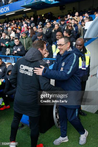 Jan Siewert head coach of Huddersfield Town is welcomed by Maurizio Sarri of Chelsea ahead of the Premier League match between Chelsea FC and...