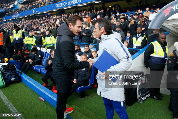 Gianfranco Zola assistant coach of Chelsea greets Jan Siewert head coach of Huddersfield Town before the Premier League match between Chelsea FC and...