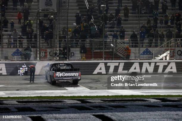 Kyle Busch, driver of the Cessna Toyota, celebrates after winning the NASCAR Gander Outdoors Truck Series Ultimate Tailgating 200 at Atlanta Motor...