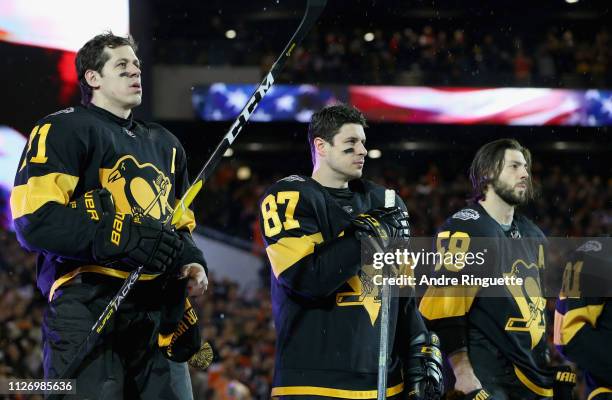 Evgeni Malkin, Sidney Crosby, Kris Letang of the Pittsburgh Penguins and their teammates line up for the singing of the National Anthem prior to the...