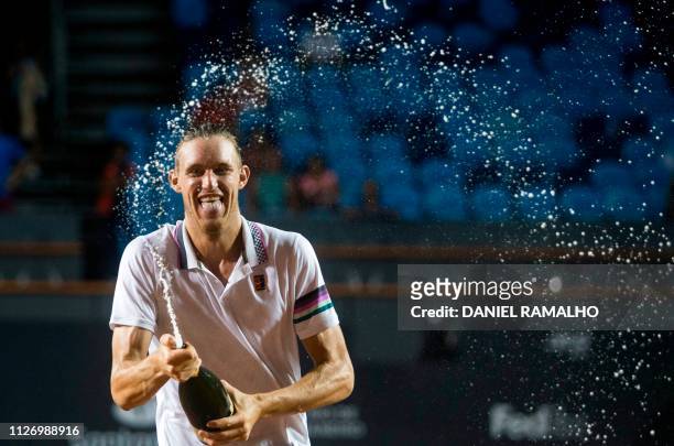 Chile's Nicolas Jarry sprays champagne as he celebrates after winning along with Argentina's Maximo Gonzalez the ATP World Tour Rio Open doubles...