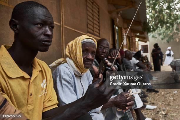 Voters wait for the opening of a polling station ahead of Presidential elections on February 24, 2019 in Fatick, Senegal. 6.7 million voters are...