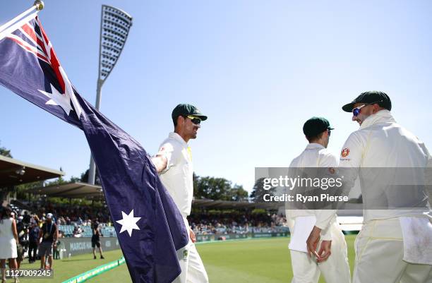 Mitchell Starc and Nathan Lyon of Australia walks out to field during day three of the Second Test match between Australia and Sri Lanka at Manuka...