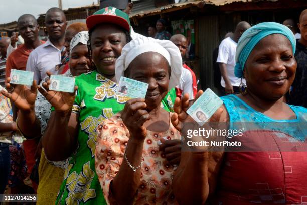 Voters display their permanent voters card during the 2019 Presidential and National Assembly elections in Lagos on Saturday, February 23, 2019.