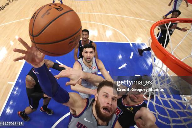 Blake Griffin of the Detroit Pistons triers to get a shot off past Boban Marjanovic of the LA Clippers during the first half at Little Caesars Arena...