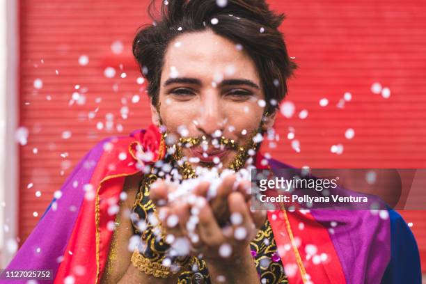 homem blow konfetti från händerna - traditional festival bildbanksfoton och bilder