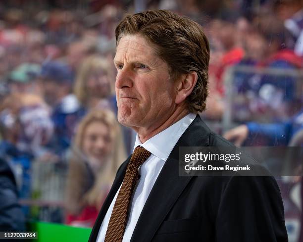 Head coach Mike Babcock of the Toronto Maple Leafs watches the action from the bench against the Detroit Red Wings during an NHL game at Little...