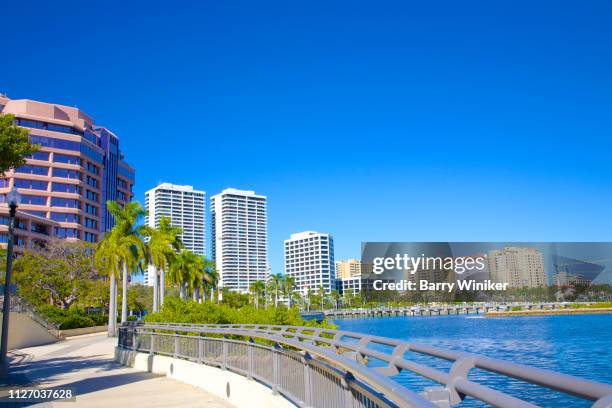 curved pedestrian walkway near lagoon in west palm beach - west palm beach stock pictures, royalty-free photos & images