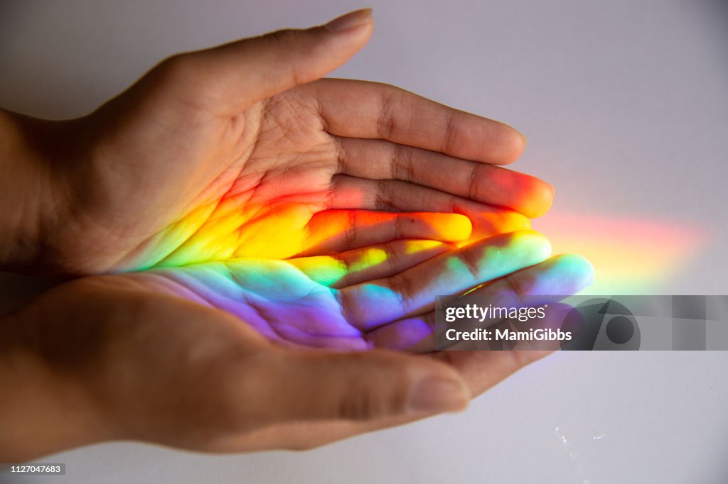 Rainbow reflected human hands