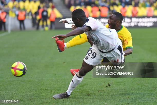 Bordeaux's French defender Maxime Poundje vies with Nantes' Ghanean forward Majeed Waris during the French L1 football match between Nantes and...