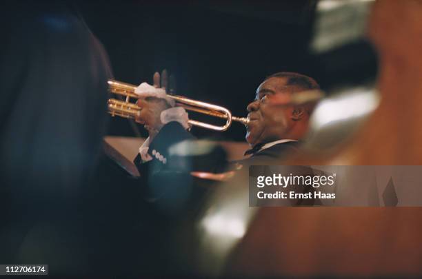 American jazz trumpeter and singer Louis Armstrong performs at the Newport Jazz Festival in Rhode Island, 1958.