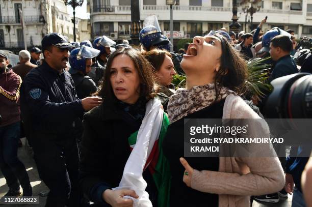 Algerian protesters shout slogans as they demonstrate in the capital Algiers against their president's bid for a fifth term on February 24, 2019....