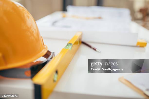 table with hard-hat and blueprints - service design stock pictures, royalty-free photos & images