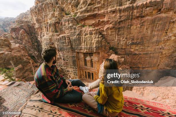 couple looking at al-khazneh in petra - archaeology excavation stock pictures, royalty-free photos & images