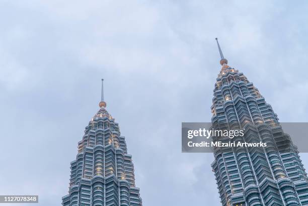 blue hour scene at petronas twin towers klcc - kuala lumpur twin tower stock pictures, royalty-free photos & images